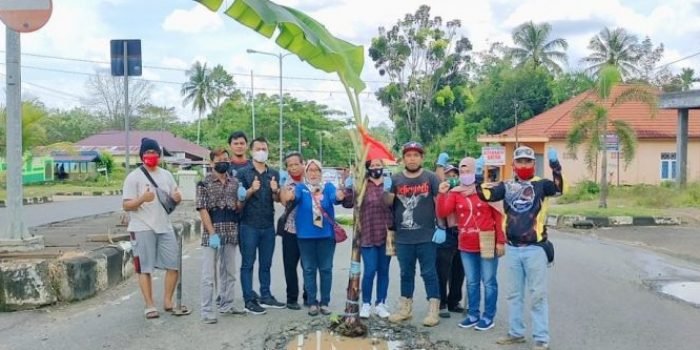 Aksi tanam pohon pisang di tengah jalan sebagai bentuk protes terhadap rusaknya jalan umum.Foto : BorneoFlash.com/Lilis Suryani.