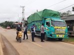 Petugas melakukan Pemeriksaan kepada pengendara roda dua maupun roda empat yang ingin masuk maupun keluar di Posko Penyekatan perbatasan kabupaten yang berada di Kampung Jambuk Makmur, Kecamatan Bongan Kabupaten Kutai Barat. Foto : HO.