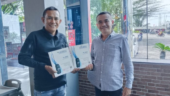 H Bisri Mustofa menyerahkan dua buah HT kepada relawan info bencana Kota Balikpapan Ruslan, pada pada hari Senin (23/10/2023). Foto: BorneoFlash.com/Niken Sulastri.