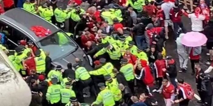 Polisi mengamankan mobil abu-abu dari amukan massa. Foto: telegraph.co.uk