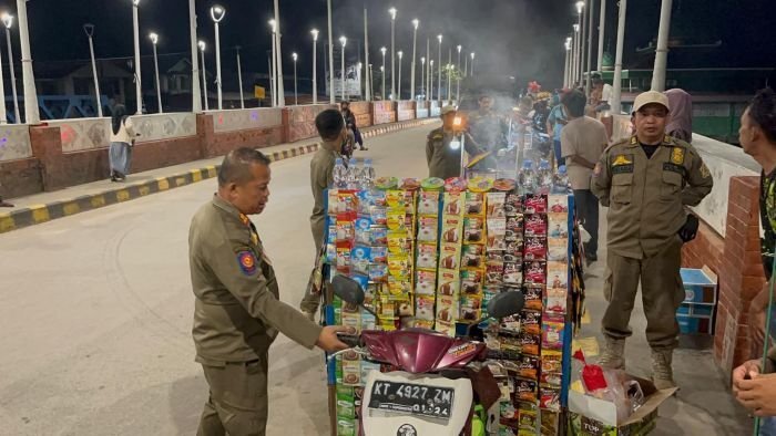 Satpol PP Kota Balikpapan menggelar razia yustisi kepada para PKl di Jembatan Manggar Kecamatan Balikpapan Timur, pada Minggu (20/7/2025) malam. Foto: BorneoFlash/Niken Sulastri