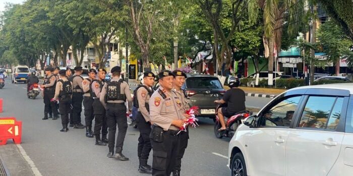 Suasana semarak jelang peringatan Hari Ulang Tahun ke-80 Kemerdekaan Republik Indonesia, jajaran Polresta Balikpapan turun langsung ke jalan membagikan ratusan Bendera Merah Putih kepada para pengendara. Foto: BorneoFlash/Agung Putra