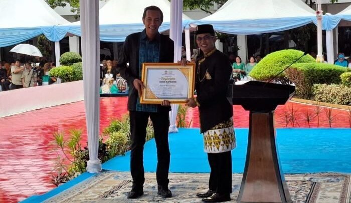 Wali Kota Balikpapan, H. Rahmad Mas'ud menyerahkan penghargaan kepada Yanuar Riswandanu sebagai warga berprestasi, pada Peringatan HUT ke 129 Balikpapan, di Halaman Balai Kota Balikpapan, pada Selasa (10/2/2026). Foto: BorneoFlash/Niken Sulastri